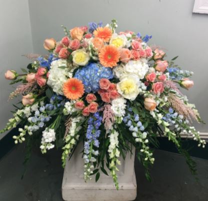 Coral Sunset Casket Spray | Bloom Funeral